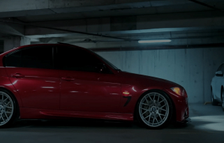 Red sedan with tinted windows parked in a covered garage
