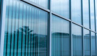 Tinted glass curtain wall running along a commercial building